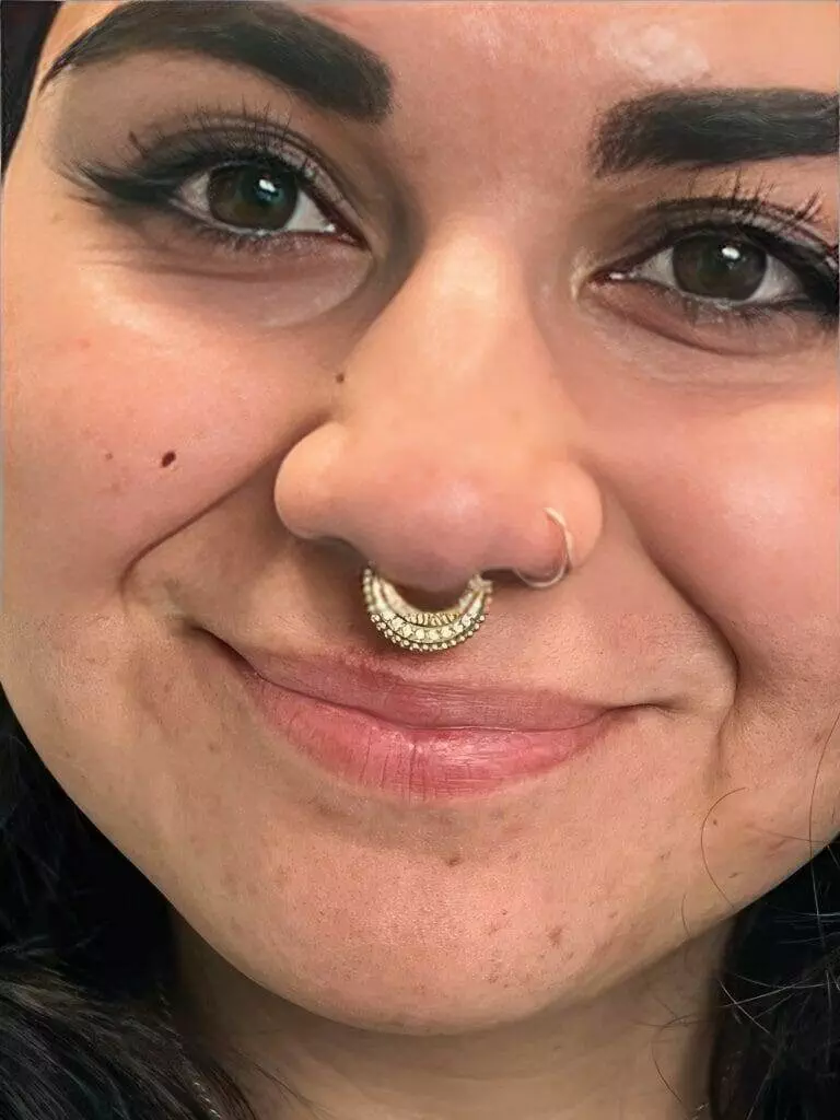 A woman named Ronnie with a gold nose piercing.