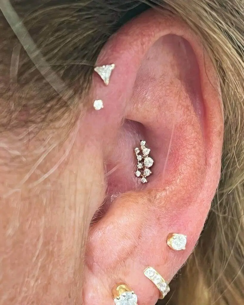 A woman's ear with a diamond piercing.